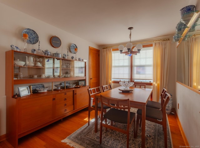 dining room featuring hardwood / wood-style floors and an inviting chandelier