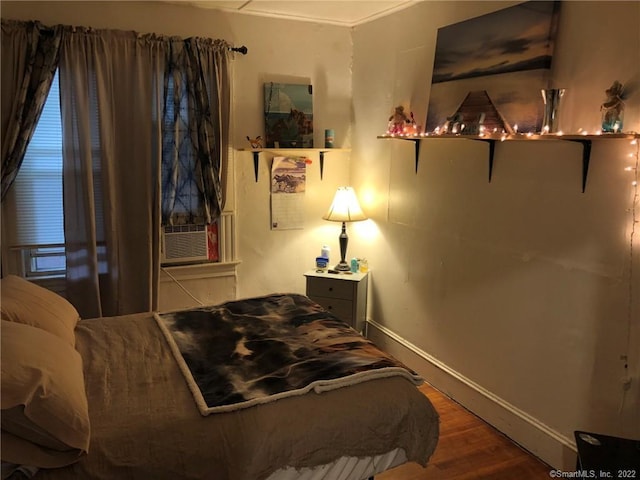 bedroom with wood-type flooring and cooling unit