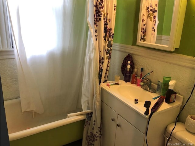 bathroom featuring a wealth of natural light, vanity, and toilet