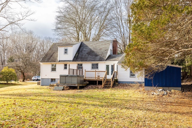 back of property featuring a lawn and a wooden deck