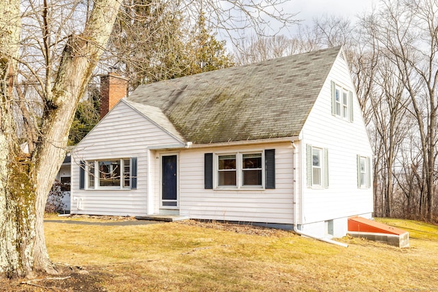 cape cod-style house with a front lawn