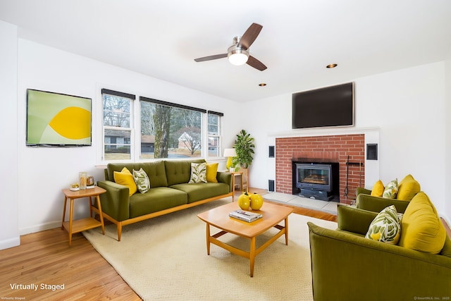 living room with ceiling fan and light hardwood / wood-style floors