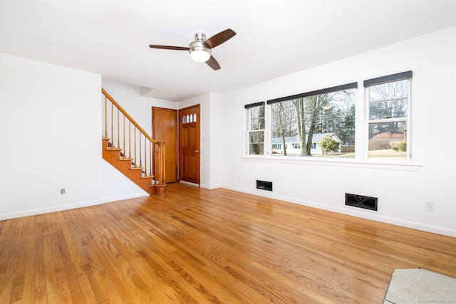 unfurnished living room featuring ceiling fan and light wood-type flooring