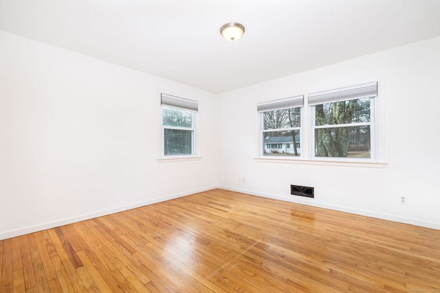 spare room with light wood-type flooring