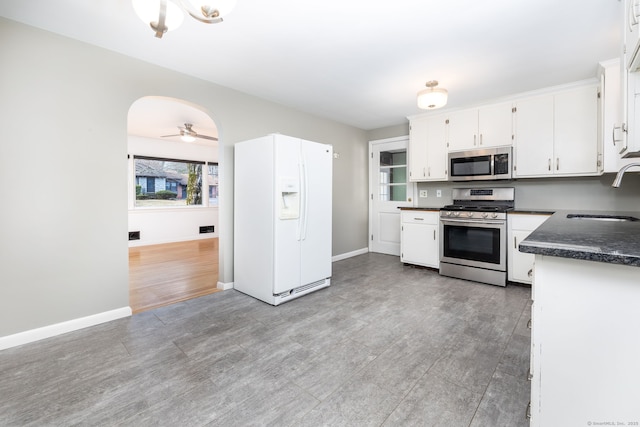 kitchen featuring white cabinets, sink, ceiling fan, appliances with stainless steel finishes, and light hardwood / wood-style floors