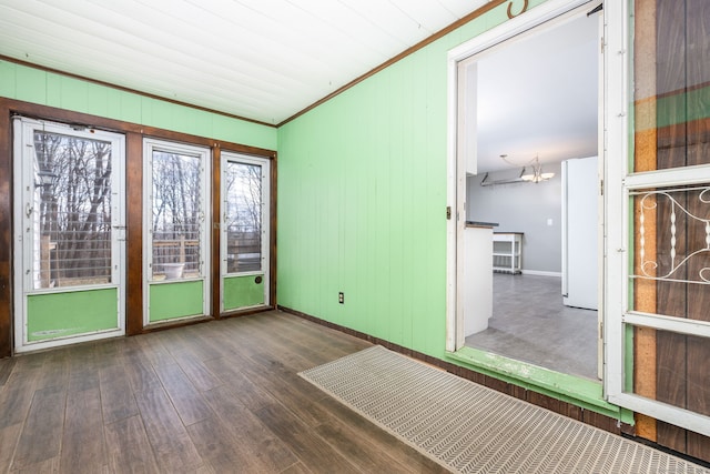 unfurnished sunroom featuring a chandelier