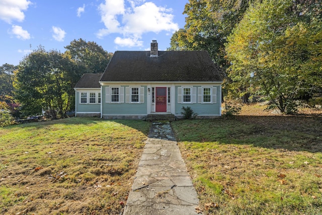 cape cod house featuring a front lawn