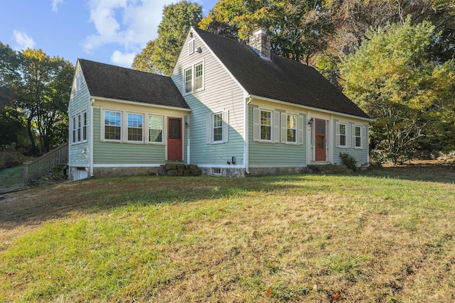 cape cod home featuring a front yard