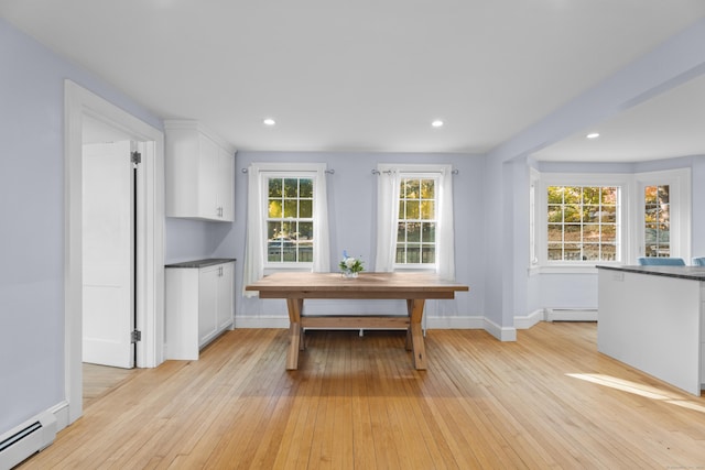 dining room featuring light wood-type flooring and a baseboard radiator