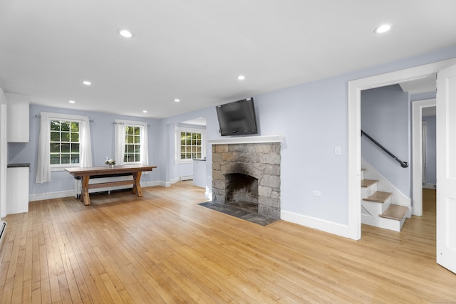 living room featuring a fireplace and light hardwood / wood-style flooring