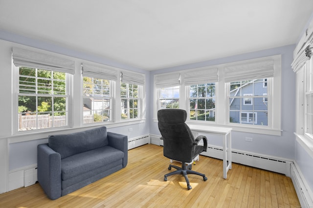 office featuring baseboard heating, plenty of natural light, and light hardwood / wood-style flooring