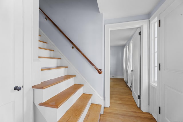 stairs featuring hardwood / wood-style flooring