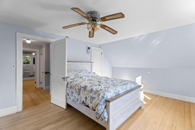 bedroom featuring light wood-type flooring, ceiling fan, and lofted ceiling