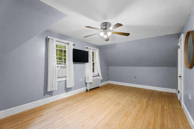 bonus room with radiator, ceiling fan, light hardwood / wood-style flooring, and lofted ceiling