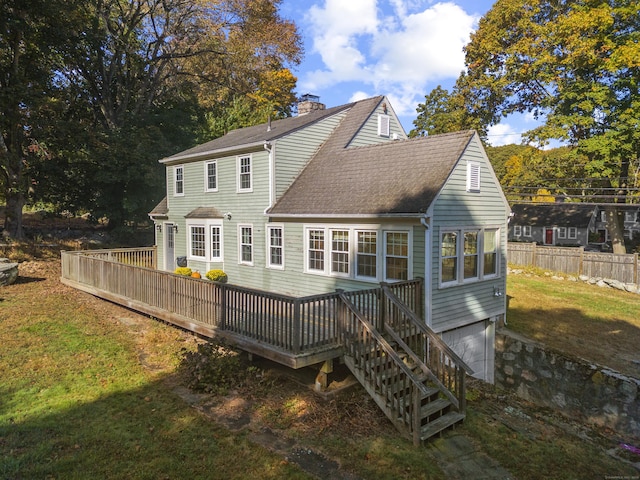 back of house with a yard and a wooden deck