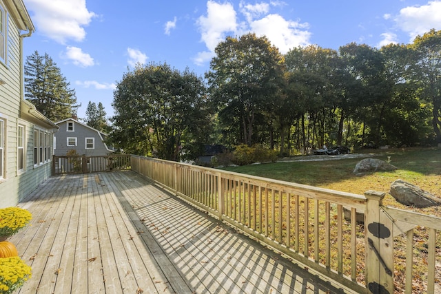 wooden terrace with a lawn