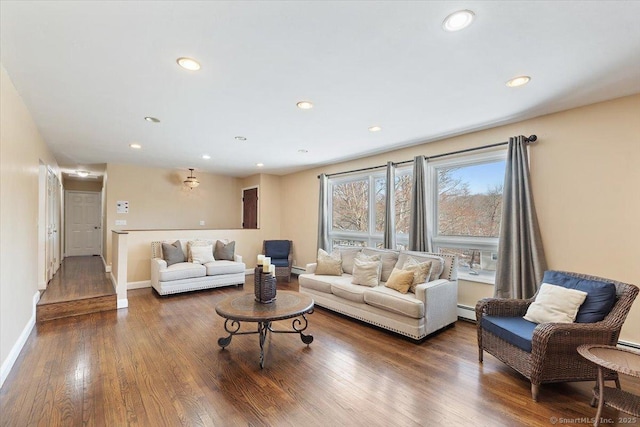 living room featuring dark hardwood / wood-style flooring and a baseboard heating unit