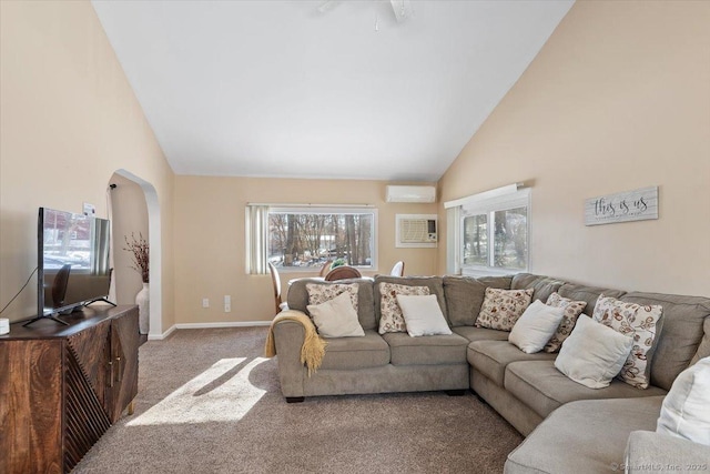 living room with an AC wall unit, a wealth of natural light, and carpet