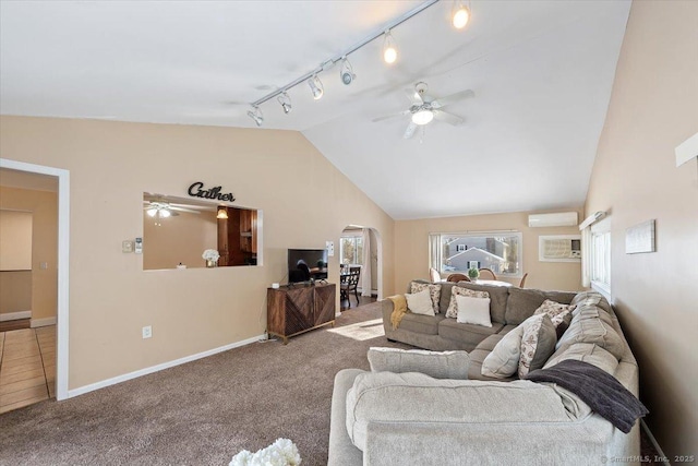 living room with carpet, a wall mounted air conditioner, lofted ceiling, track lighting, and ceiling fan