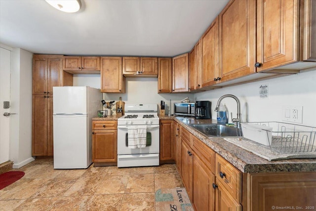 kitchen featuring white appliances and sink