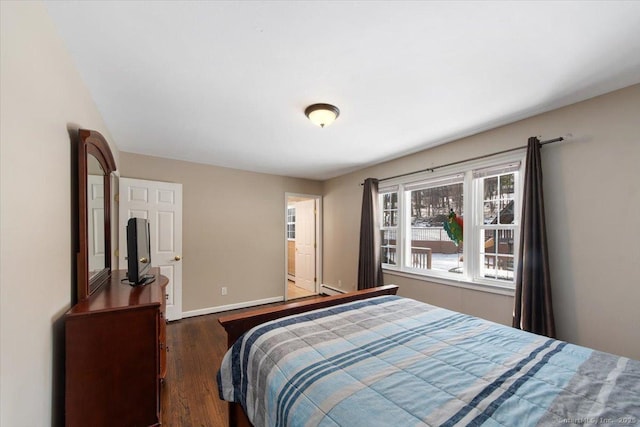 bedroom with dark hardwood / wood-style floors