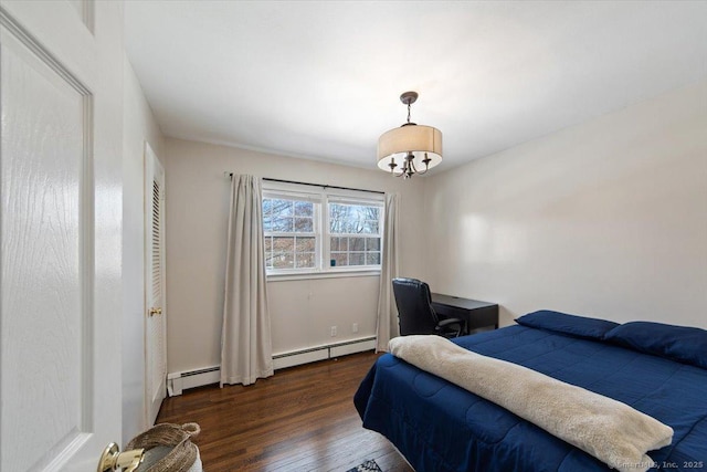 bedroom with a chandelier, dark wood-type flooring, and a baseboard heating unit