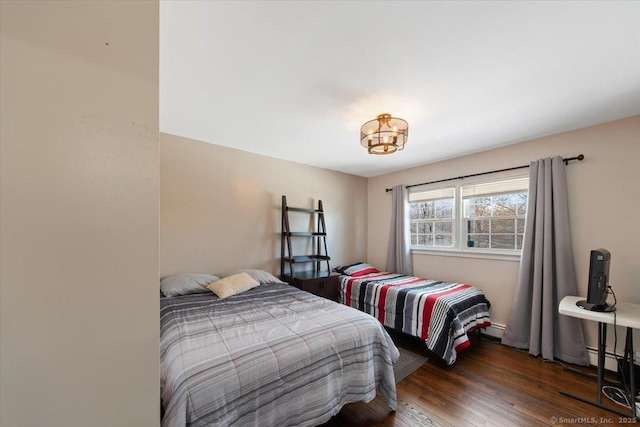 bedroom with dark hardwood / wood-style flooring and a baseboard radiator