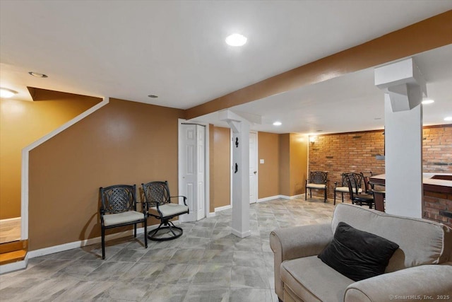 sitting room with brick wall