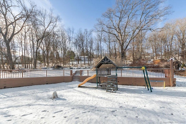 snowy yard with a playground