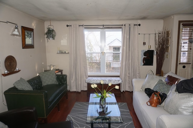 living room with dark wood-type flooring and crown molding