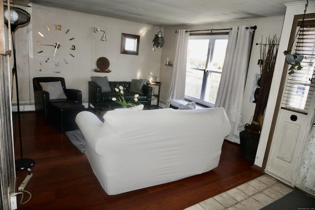 living room featuring a baseboard heating unit and hardwood / wood-style floors