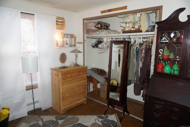 walk in closet featuring baseboard heating and dark parquet flooring