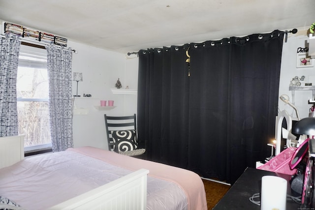 bedroom featuring dark parquet flooring