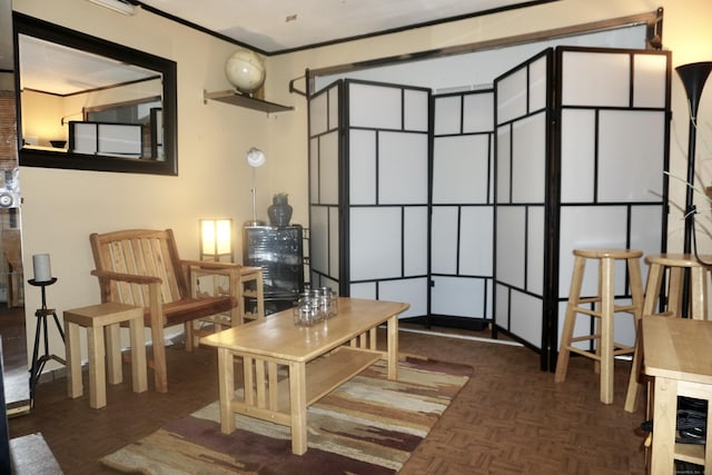 living area featuring dark parquet flooring and ornamental molding