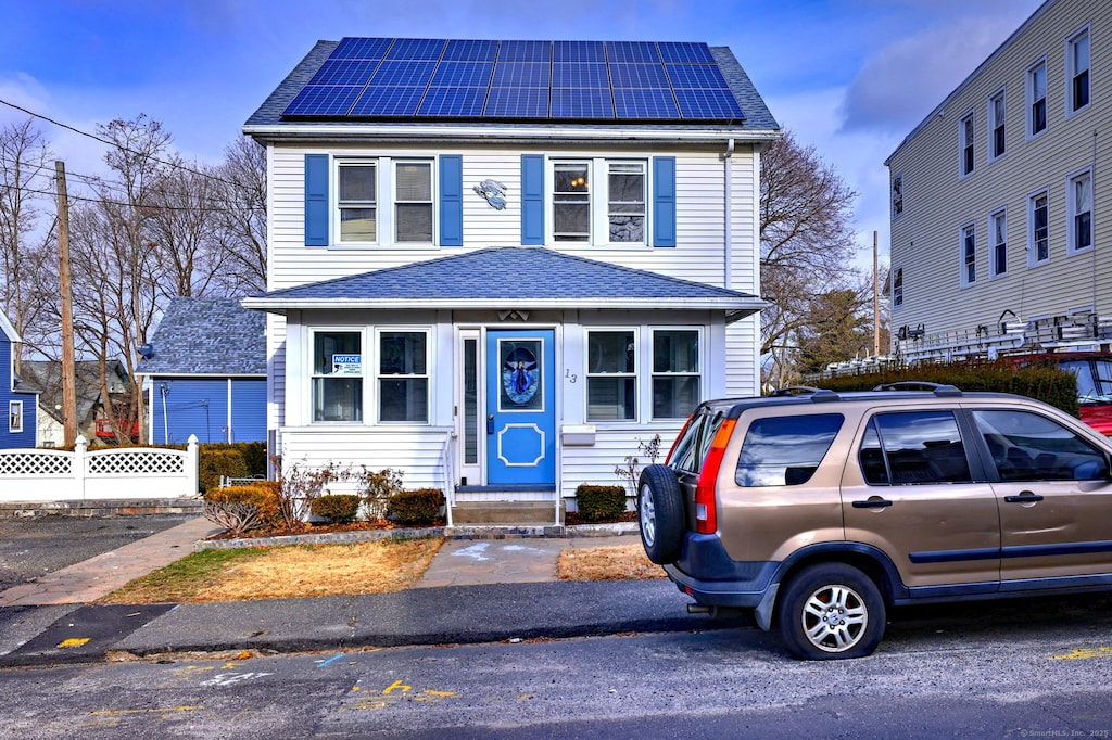 view of front facade with solar panels