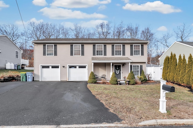 view of front of property with a front yard and a garage