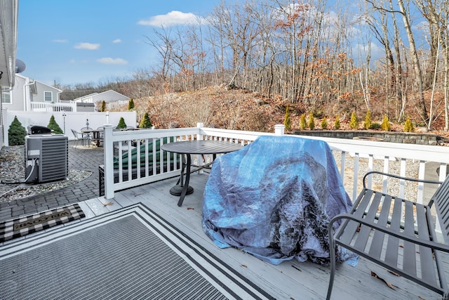 wooden deck with central AC and a grill