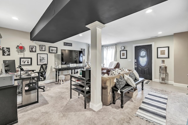 carpeted living room with ornate columns