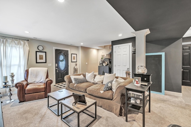 carpeted living room featuring ornate columns