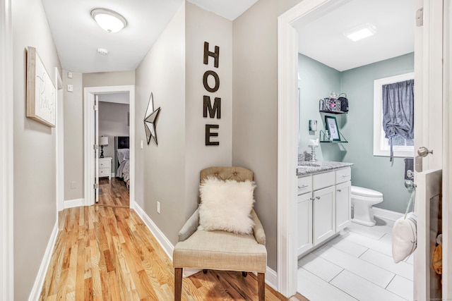 corridor with light hardwood / wood-style flooring