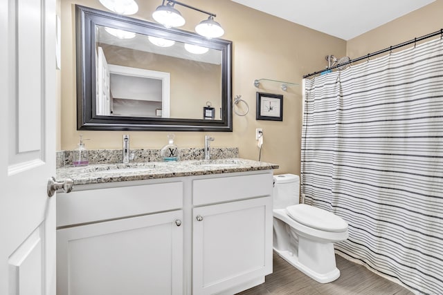 bathroom featuring a shower with curtain, vanity, and toilet