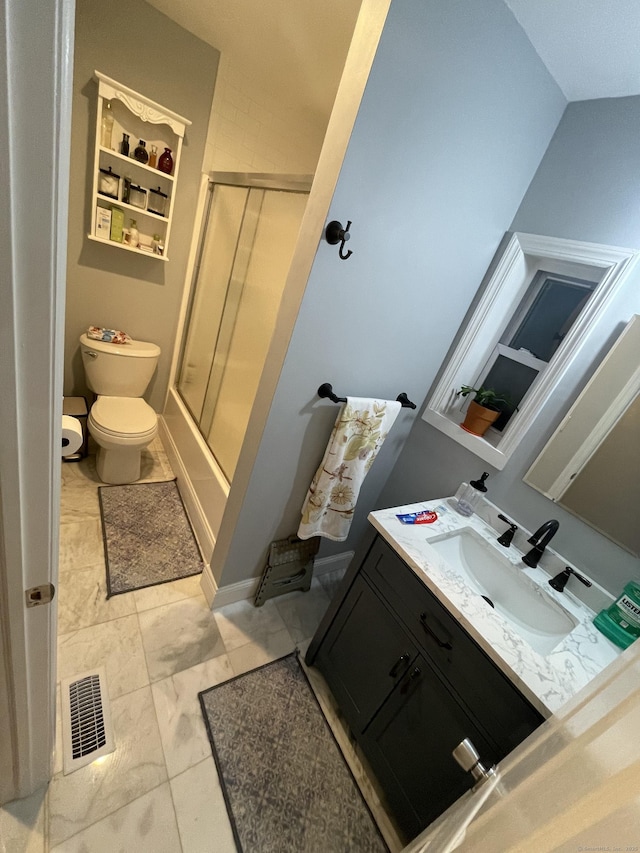 bathroom with a shower with door, vanity, and toilet