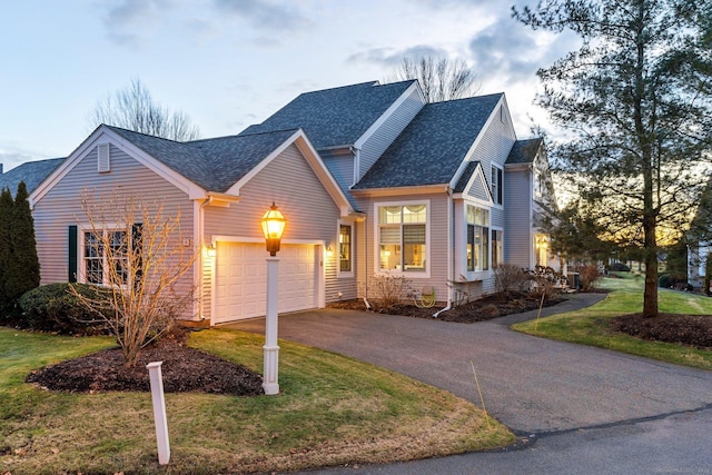 view of front of property featuring a lawn and a garage