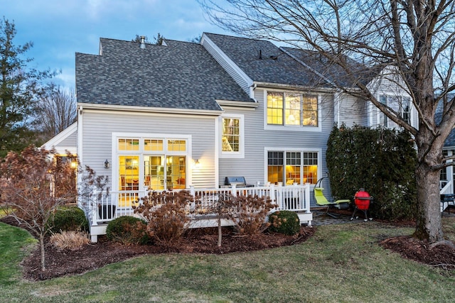 back of house with a lawn