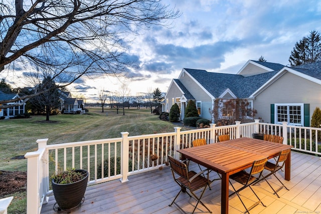 wooden deck featuring a lawn