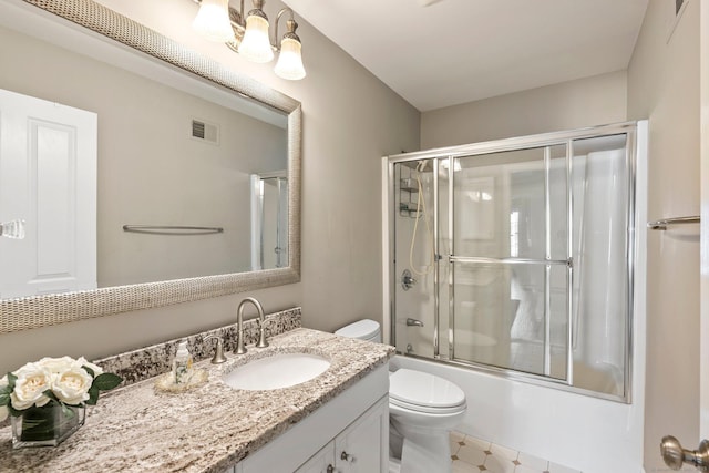 full bathroom with toilet, combined bath / shower with glass door, and vanity