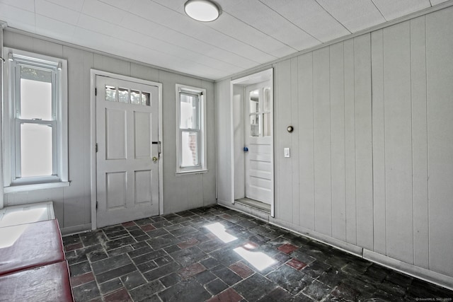 entryway featuring wooden walls