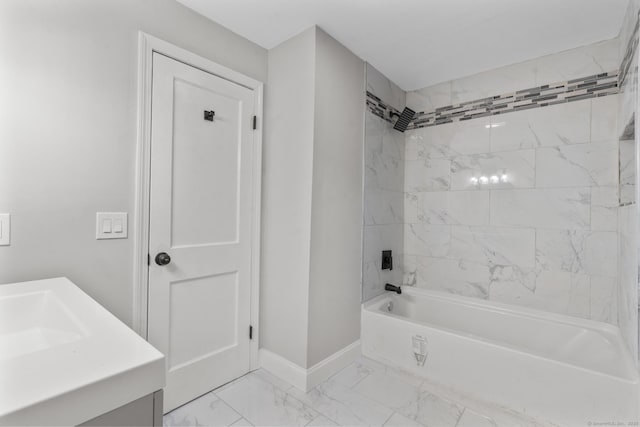 bathroom featuring vanity and tiled shower / bath