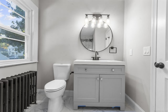 bathroom with toilet, radiator, and vanity