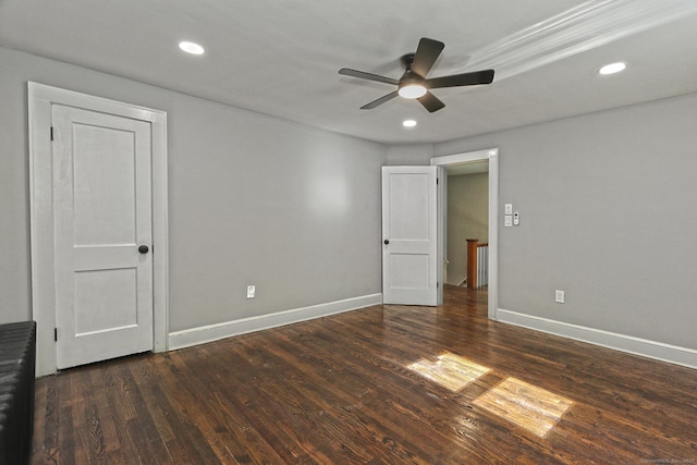 empty room featuring ceiling fan and dark hardwood / wood-style flooring